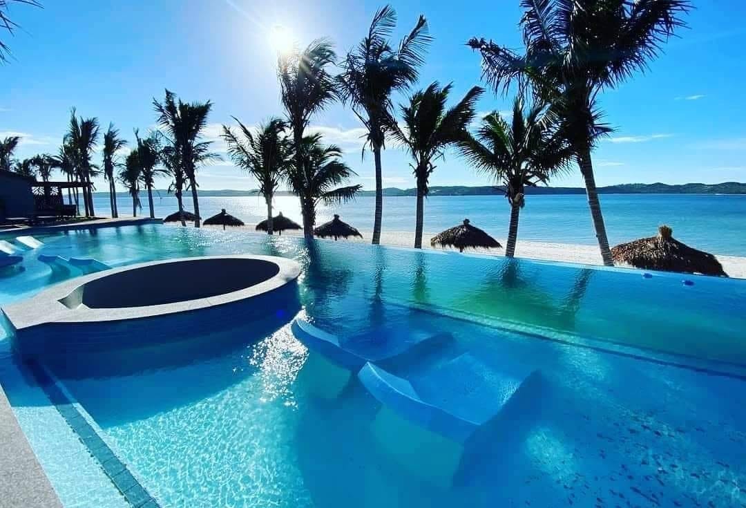 Oceanfront resort pool overlooking a tropical beach
