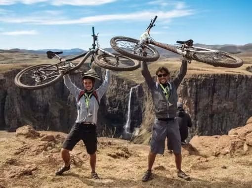 Cyclists celebrating beside Maletsunyane Falls