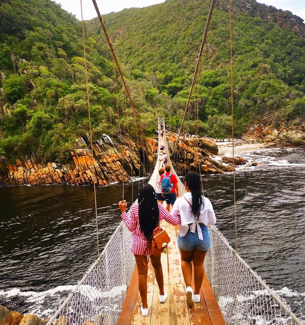 Travellers crossing a suspension bridge in Tsitsikamma